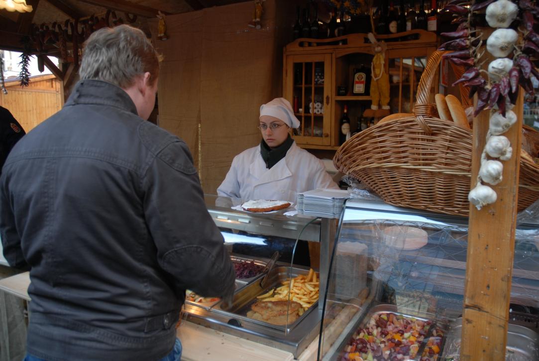 Philipp buying a potato pancake with cream