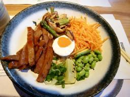 barbecue-glazed seitan served with a coconut + sriracha vegan ‘egg’, grilled shiitake mushrooms and asparagus on a bed of brown rice. topped with edamame beans, carrots and spring onions. dressed with a sweet amai sauce and garnished with sesame seeds and fresh lime //20 Sumner Street, London SE1 9JZ England